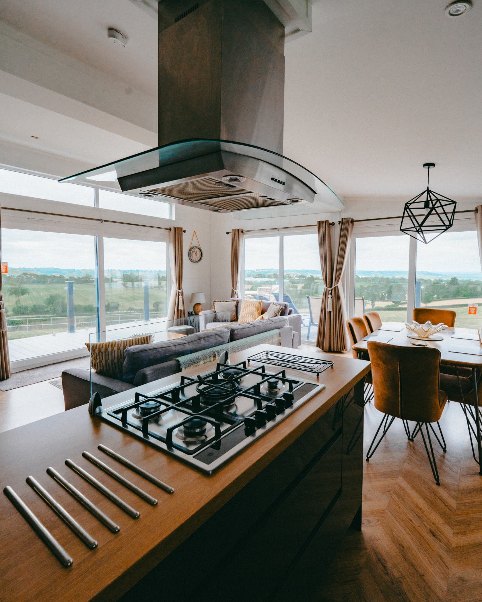 A portrait view of the Symphony Suite's kitchen island and open-plan living area, with countryside views.